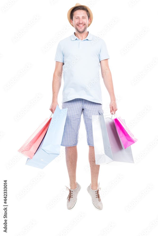 Vertical full length studio portrait of handsome man wearing summer outfit carrying shopping bags, white background Vertical full length studio portrait of handsome man wearing summer outfit carrying shopping bags, white background