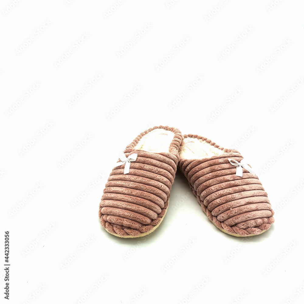 Obraz premium Women's warm home slippers. Made of pink embossed plush, decorated with bows. Isolated over white background.