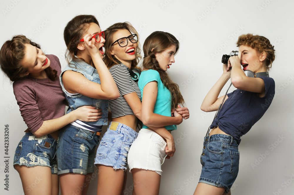 Happy girls friends taking some pictures with camera Happy girls friends taking some pictures with camera