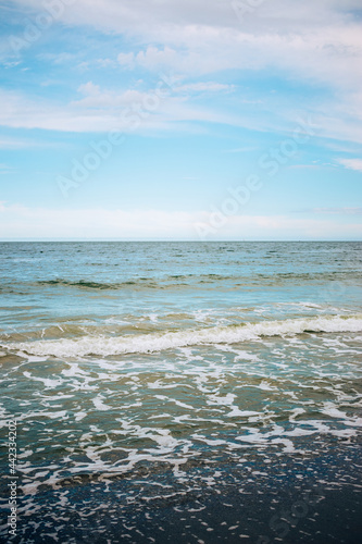 Sandy seashore view with waves