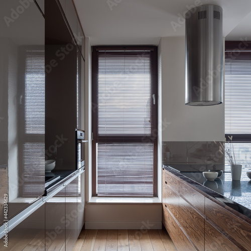 Big window with blinds in long kitchen