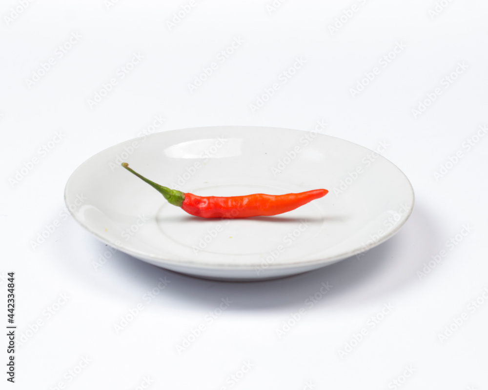 Red chili isolated on white background. This chili has a taste that is not so spicy. Usually used for a mixture of cooking spices. Consuming chili can prevent cancer and prolong life. Chili mockup. Red chili isolated on white background. This chili has a taste that is not so spicy. Usually used for a mixture of cooking spices. Consuming chili can prevent cancer and prolong life. Chili mockup.