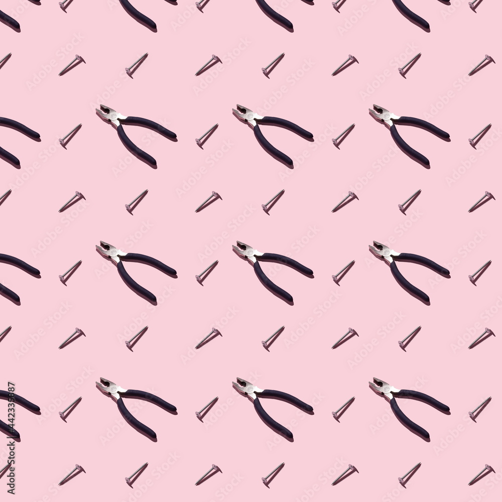 Pliers and self-tapping screws on a pink background, pattern, hard shadows. Construction tools, repairs. Background for the design. Pliers and self-tapping screws on a pink background, pattern, hard shadows. Construction tools, repairs. Background for the design.