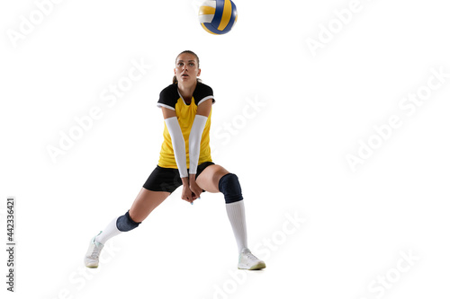 Female professional volleyball player with ball isolated on white studio background. The athlete, exercise, action, sport, healthy lifestyle, training, fitness concept.