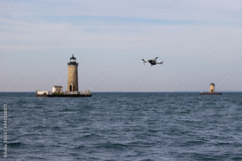 drone flying between two lighthouses