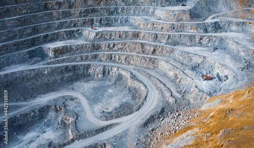 Photography Open pit stone quarry aerial view with terraces and colorful tailings