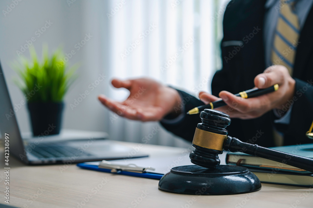 A lawyer or judge provides legal advice to clients in an attorney's office. legal advisor Scales of Justice, Law Hammer, Litigation and Justice A lawyer or judge provides legal advice to clients in an attorney's office. legal advisor Scales of Justice, Law Hammer, Litigation and Justice