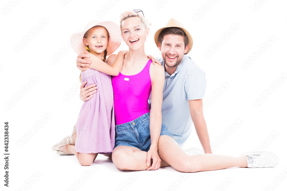 Horizontal studio portrait of family with cute daughter wearing summer outfits sitting on floor, white background