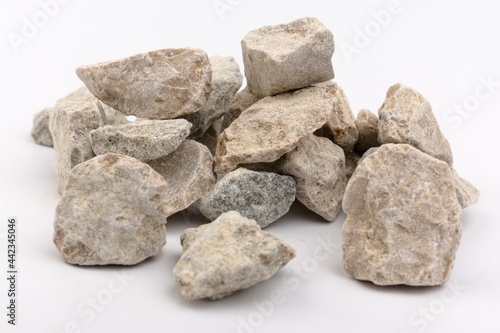 Gray small rocks ground texture isolated on white background. Small road stone.