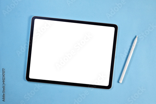 Blank screen tablet with pencil isolated on blue background