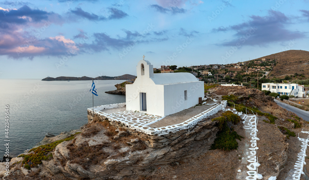 Greece, Kea Tzia island. Small white church on a rocky hill, over Korissia port