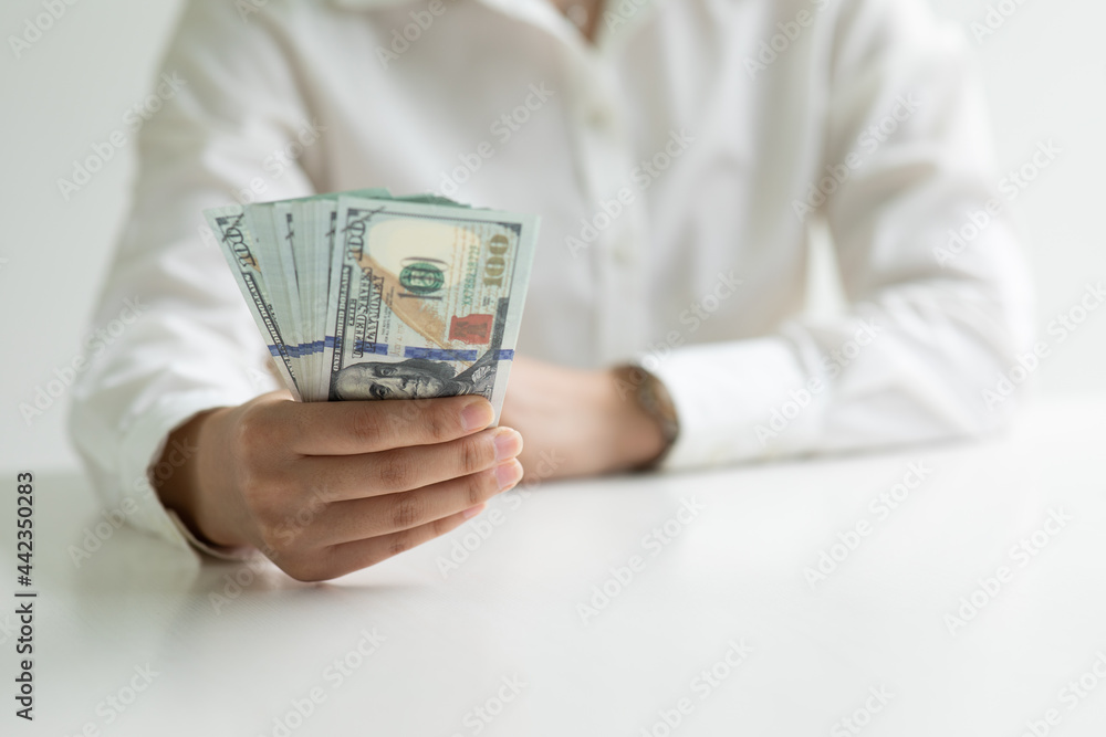 Close up of Business woman with calculator counting money and making notes at home,savings, finances, economy and home concept. Close up of Business woman with calculator counting money and making notes at home,savings, finances, economy and home concept.