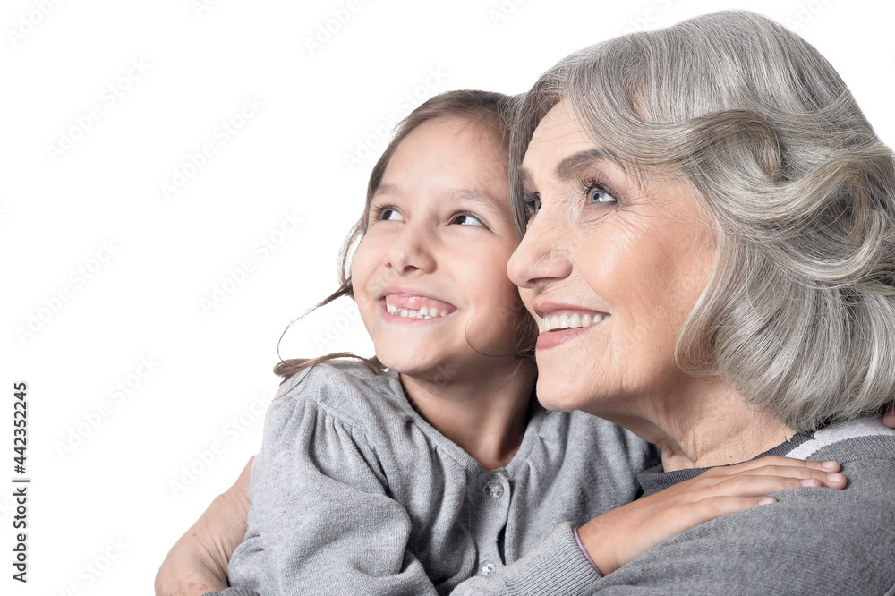 Portrait of happy grandmother and granddaughter looking at the distance isolated on white background Portrait of happy grandmother and granddaughter looking at the distance isolated on white background
