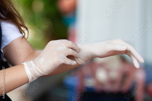 woman wearing rubber gloves to prevent germs.