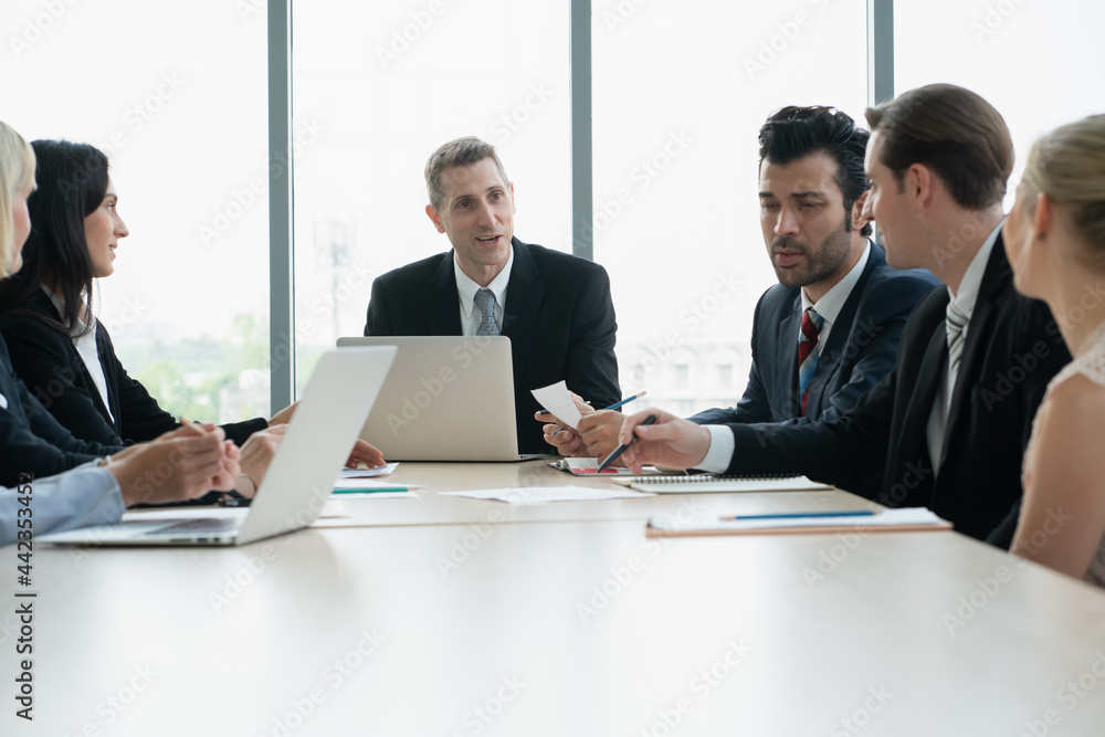 group of business people working and disussing a project together at meeting room group of business people working and disussing a project together at meeting room