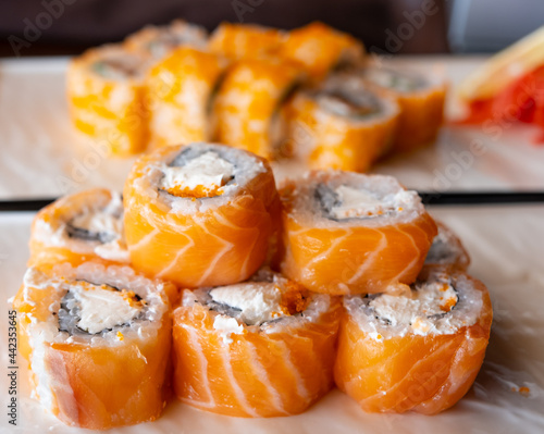 Sushi roll with salmon, avocado and cheese. Tasty food. Fish and rice.