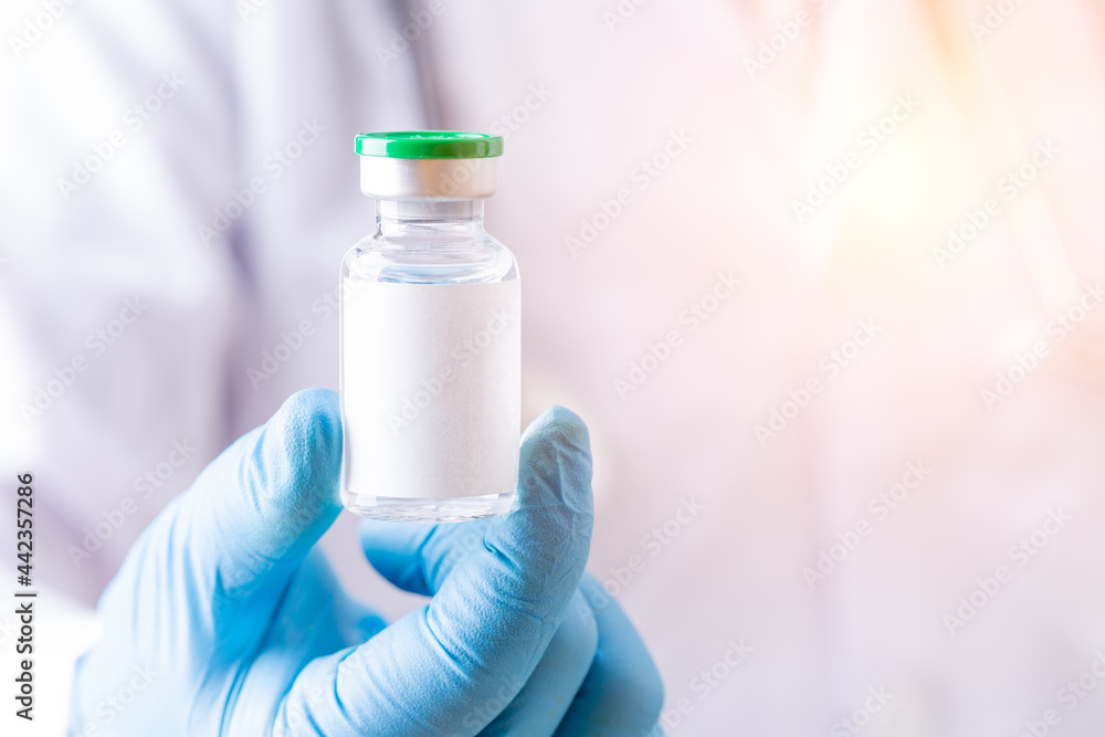 Doctor holding single bottle vial of vaccine for children or adults. Concept fight against virus. Medical health care concept vaccination hypodermic injection treatment medicine and drug conceptual. Doctor holding single bottle vial of vaccine for children or adults. Concept fight against virus. Medical health care concept vaccination hypodermic injection treatment medicine and drug conceptual.