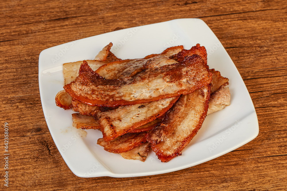Roasted juicy bacon in the plate