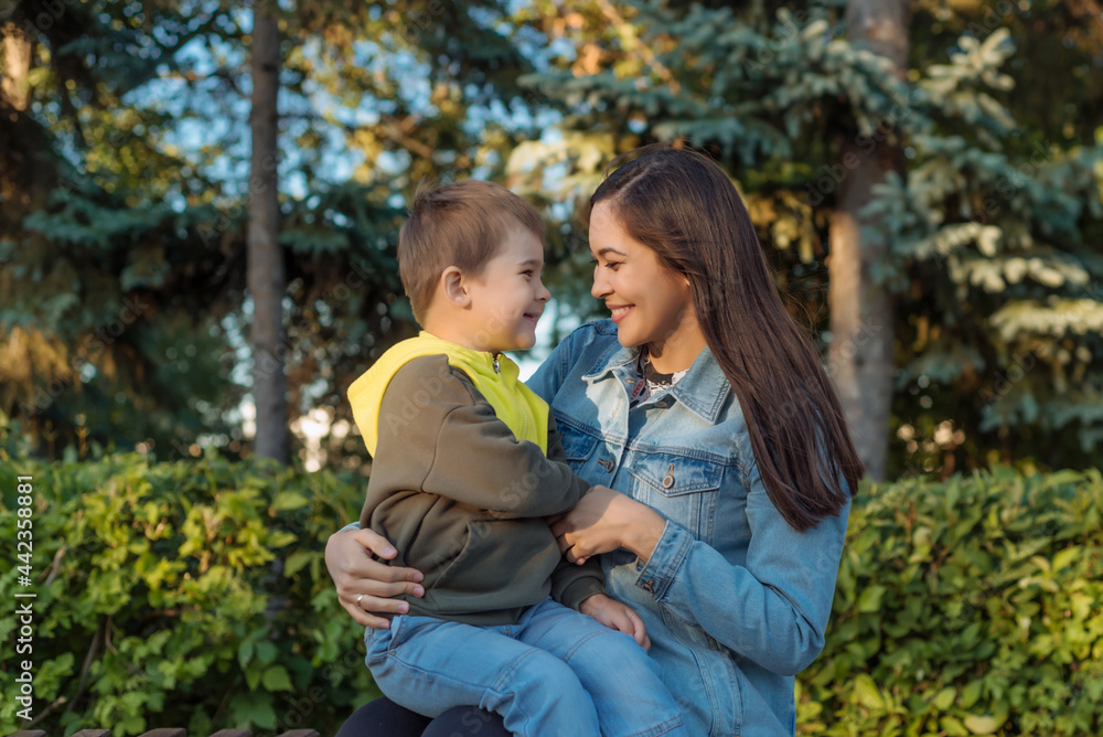 portrait of a happy young mother with a young son in the park. the concept of happy motherhood portrait of a happy young mother with a young son in the park. the concept of happy motherhood