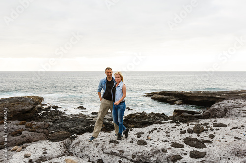 Romantic couple on the beach in a colorful sunset in the background. A guy and a girl at sunset on the island of Tenerife