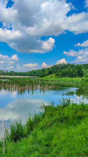 Landscape with a lake and clouds in the sky in the summer season