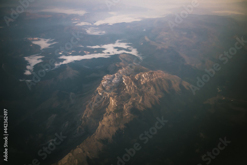 panoramic asian mountains view at sunrise from plane