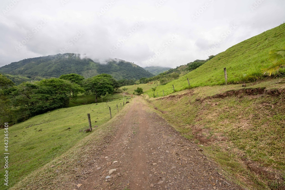 Rural landscape with road to the farm and cloudy sky. Antioquia, Colombia.