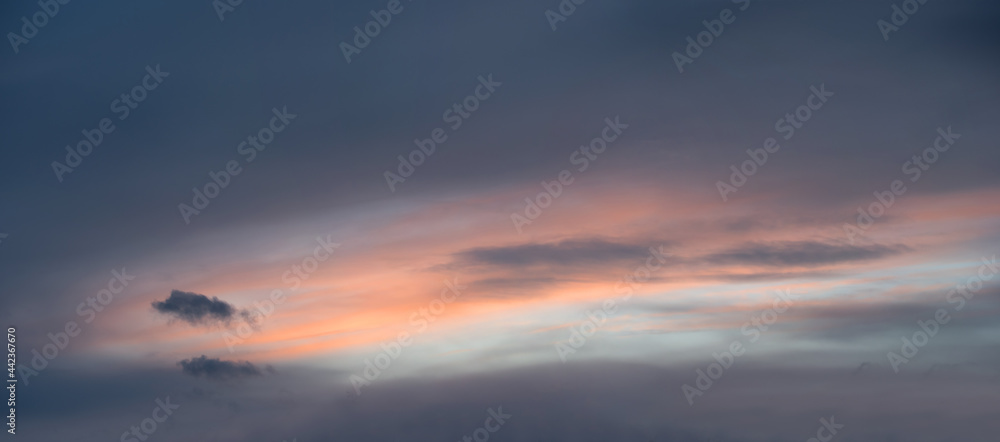 soft grey cloudscape with pastel colored middle. sky background