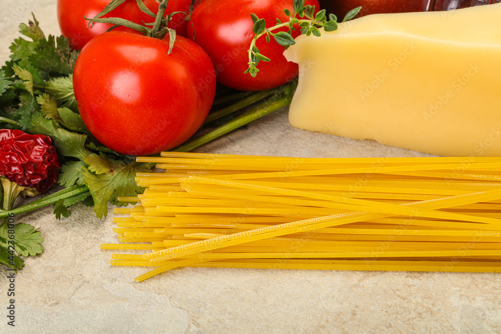 Raw Italian spaghetti heap with cheese Raw Italian spaghetti heap with cheese