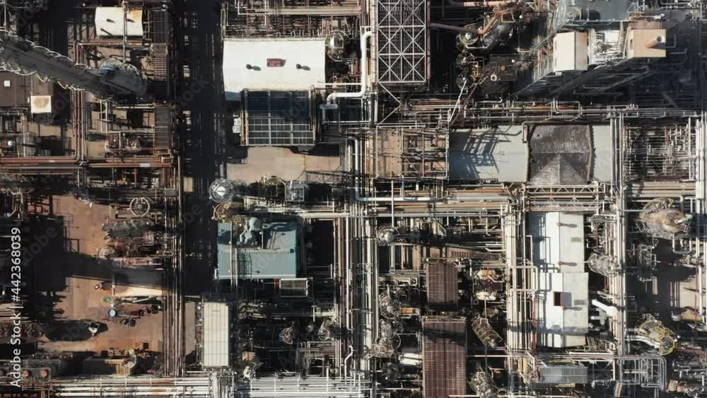 Aerial top down view of oil refinery plant, production line with metal pipes in industry zone Aerial top down view of oil refinery plant, production line with metal pipes in industry zone