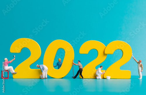 Miniature people worker team painting number 2022 , Happy new year concept