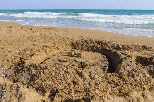 Sandcastles on the sunny sea background