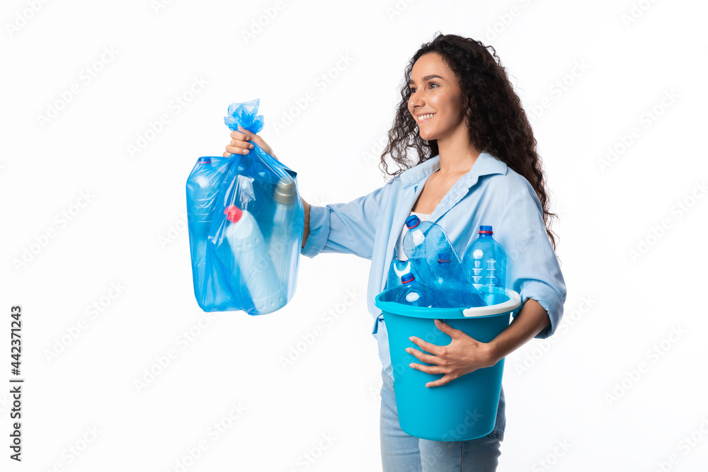 Happy Female Giving Bag With Plastic Litter Looking Aside, Studio