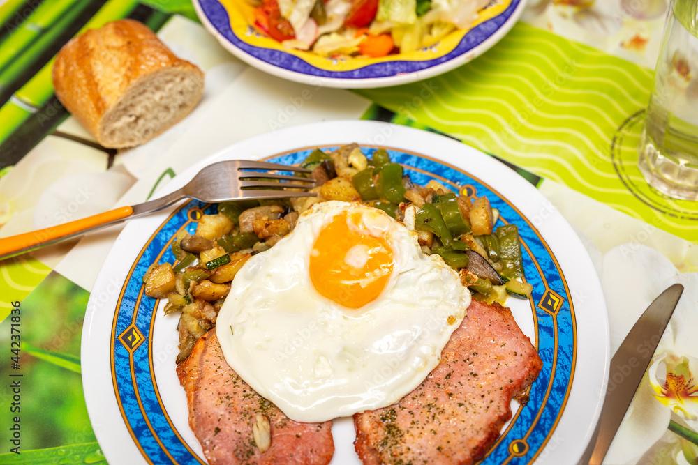 fried egg with grilled fillets pork tenderloin and vegetables. combo platter fried egg with grilled fillets pork tenderloin and vegetables. combo platter