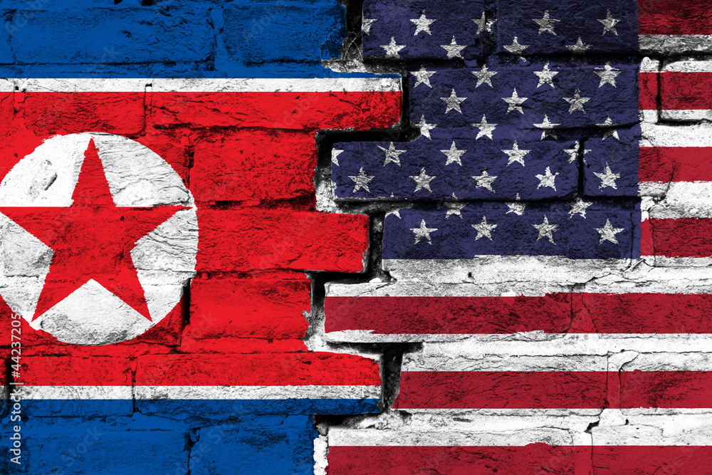 Obraz premium Concept of the relationship between North Korea and the United States of America with two painted flags on a damaged brick wall