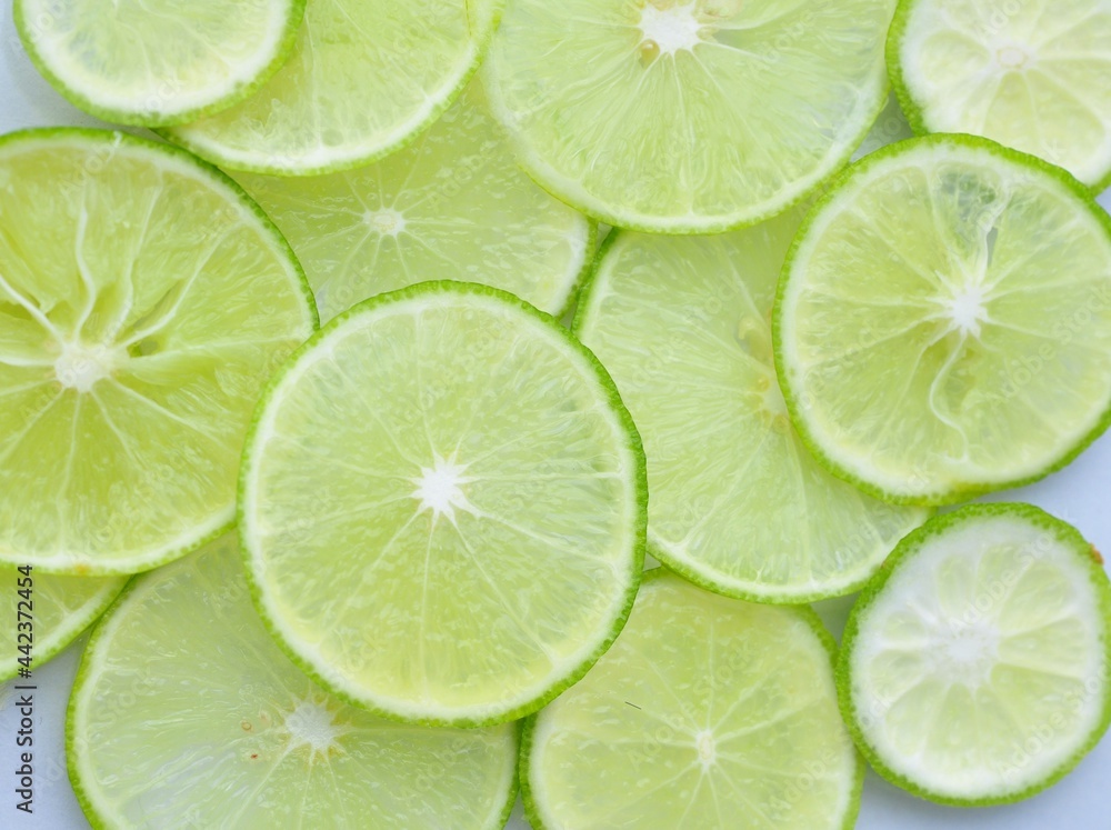 fresh green lemon of lime slices on the background