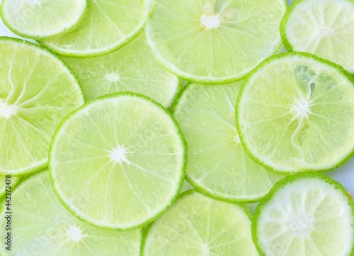 fresh green lemon of lime slices on the background