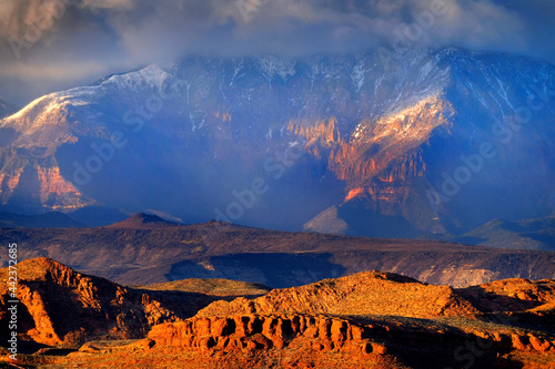 Fototapeta Naklejka Na Ścianę i Meble -  Red Cliffs Landscape Mountains Storm Clouds and Snow