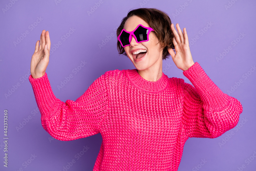 Photo of young excited girl happy positive smile have fun enjoy music dance wear sunglass isolated over violet color background Photo of young excited girl happy positive smile have fun enjoy music dance wear sunglass isolated over violet color background