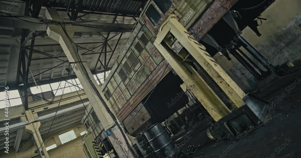 Cinematic shot: View of the old Czechoslovak locomotive ChMEZ which stands on the lift in the old repair depot of the USSR times. 4k Cinematic shot: View of the old Czechoslovak locomotive ChMEZ which stands on the lift in the old repair depot of the USSR times. 4k