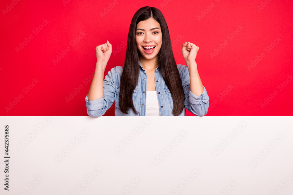 Portrait of attractive cheerful lucky girl celebrating big blank board solution ad decision isolated over bright red color background Portrait of attractive cheerful lucky girl celebrating big blank board solution ad decision isolated over bright red color background