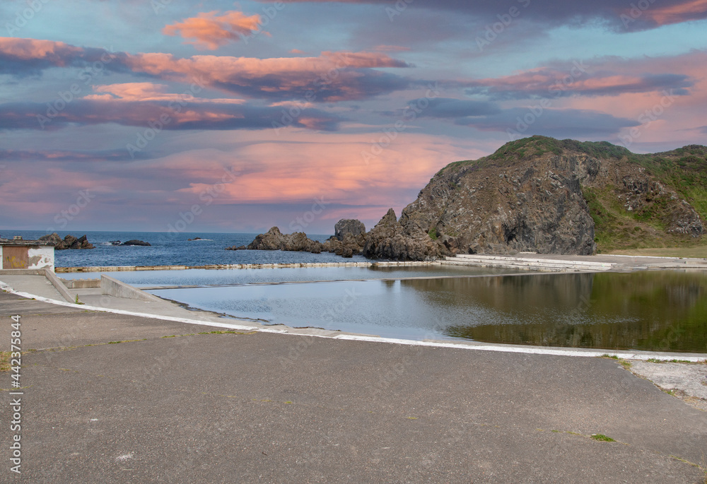 Fototapeta premium Sunrise Tarlair Swimming Pool, at Devrervon estuary, Macduff, Aberdeenshire, Scotland, UK. Tarlair Pool is in Macduff, a town on the Moray Firth in Aberdeenshire. 
