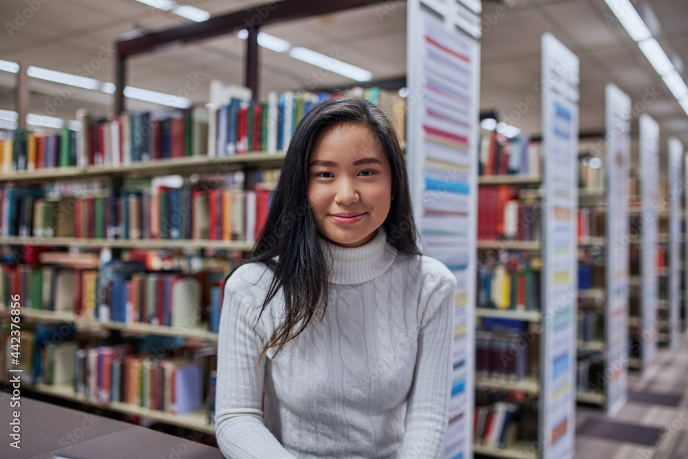 Young Asian student at university library Young Asian student at university library
