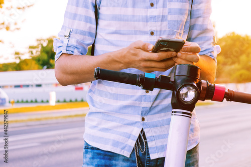 Electric scooter rental through a mobile phone in a close-up