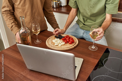 Top view of snacks and wine near male couple