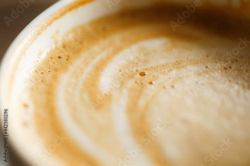 Thick milk foam in a cup of cappuccino, macro shot