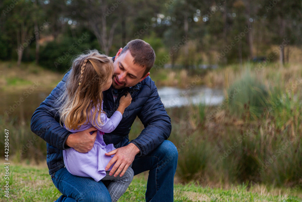Father talking with his young daughter outside Father talking with his young daughter outside