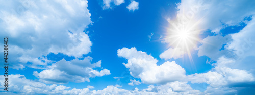 Blue sky  cloudscae background banner panorama   with clouds and sun reflection   sunshine sunbeams