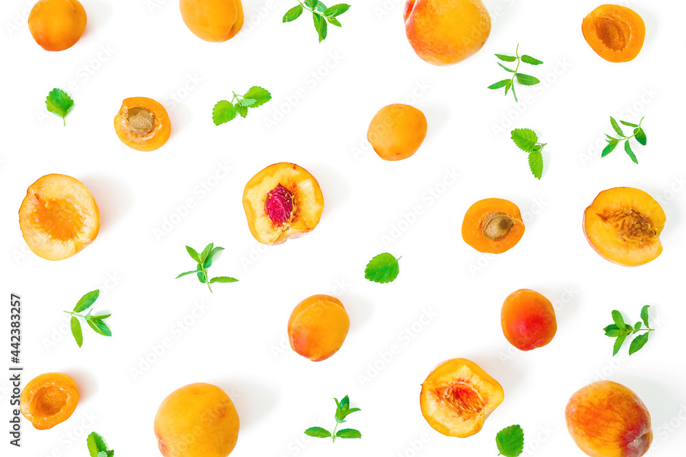 Fruit pattern of apricot and peaches with mint leaves on white background. Flat lay Fruit pattern of apricot and peaches with mint leaves on white background. Flat lay