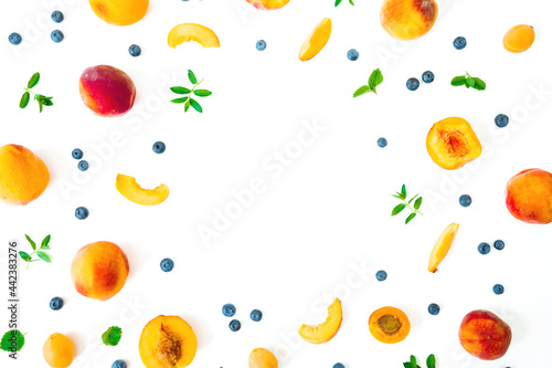 Fototapeta Naklejka Na Ścianę i Meble -  Tasty peach with blue berry and mint leaves isolated on white. Summer fruits. Top view